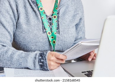 Unrecognizable Person Studying Or Working At Home Using A Sunflower Lanyard, Symbol Of People With Invisible Or Hidden Disabilities.