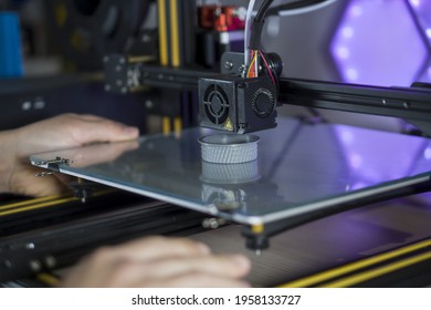 unrecognizable person taking 3d prototype for lens cap