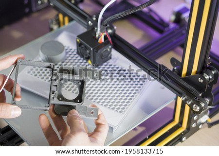 unrecognizable person taking 3d prototype for arduino