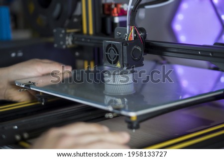 unrecognizable person taking 3d prototype for lens cap