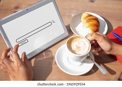 A unrecognizable person taking a break while is searching something on her tablet. Business concept.