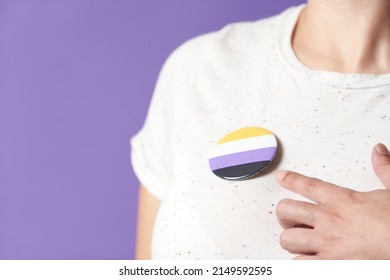 Unrecognizable Person Wearing And Pointing A Non Binary Flag Badge Or Pin. Concepts Of Identity Pride, Gender Diversity, Equality And Non Discrimination.