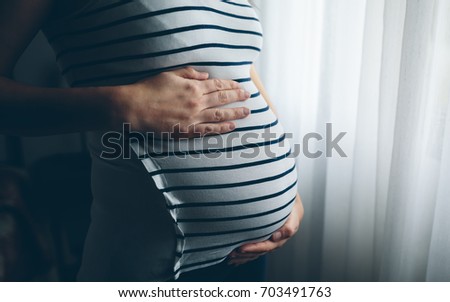 Similar – Image, Stock Photo Pregnant woman holding her tummy