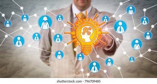 Unrecognizable Recruiter Touching A Learning Mind In Lightbulb. Concept For Artificial Intelligence, Machine Learning, Personal Development, Talent Acquisition, Knowledge Transfer And Inspiration.