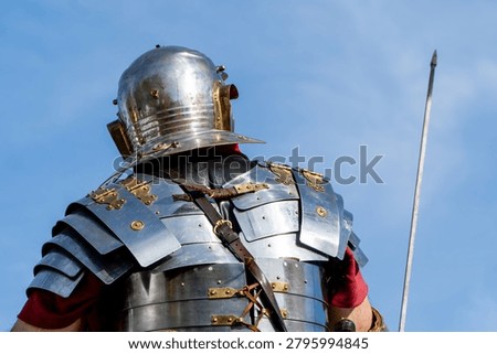 unrecognizable roman centurion with armor, shield and spear