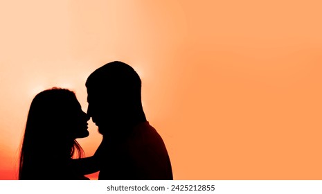 unrecognizable romantic pair in silhouette shadow close to each other and the sunset sky background. man and woman touching noses each other, kissing in sundown. sweet kiss. couple in love.  - Powered by Shutterstock