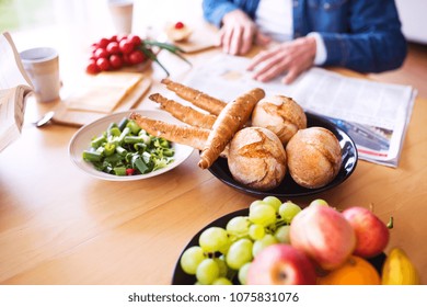 Unrecognizable Senior Couple Eating Breakfast At Home.