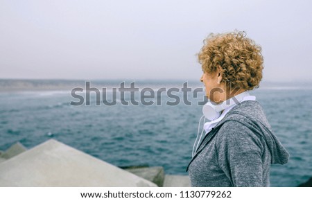 Senior sportswoman looking at the sea