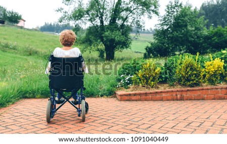 Similar – Older woman in a wheelchair