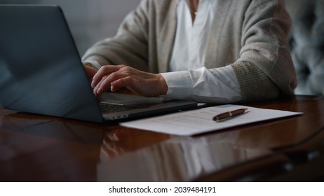 Unrecognizable Senior Woman Hands Typing Laptop Computer Keyboard In Luxury Interior. Unknown Elegant Woman Using Laptop At Home. Old Person Working On Digital Device Indoors. 