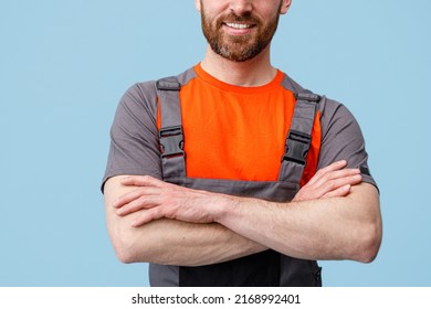 Unrecognizable smiling workerman in uniform with crossed hands looking at camera - Shutterstock ID 2168992401