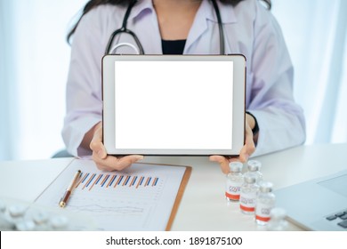 Unrecognizable Specialist Doctor Holding An Empty Blank Screen Tablet Isolated In White Close Up. Digital Display In Medication Service Advertisement. Mockup Touchscreen Tablet For Ads.