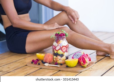 Unrecognizable sportive woman with a healthy breakfast in a mason jar - Powered by Shutterstock