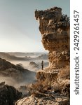
Unrecognizable vacationer standing beneath a jagged precipice in the Alps
