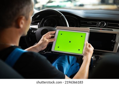 Unrecognizable Vehicle Service Manager Worker Check And Maintenance To Repair The Engine Car In Workshop. Mechanic Running Diagnostics Software On Tablet Computer With Green Screen Mockup Chromakey.