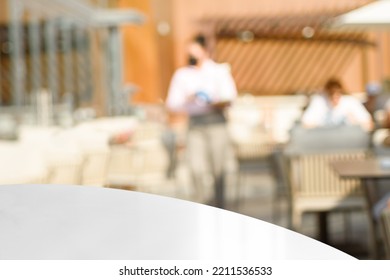 Unrecognizable Waiter In A Cafe At Work. Empty White Table For Present Product On Coffee Shop Or Soft Drink Bar Blur Background With Bokeh Image