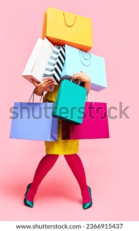Unrecognizable woman in bright clothes carrying a lot of purchases, shopping paper bags over pink studio background. concept of fashion, beauty, salesperson, Black Friday, sales. copy space. ad