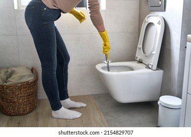 Unrecognizable woman cleaning bathroom toilet