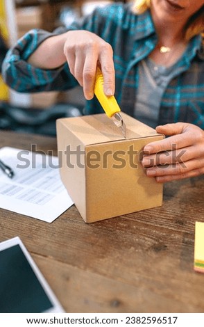 Similar – Image, Stock Photo Unrecognizable woman packing carton box with tape dispenser