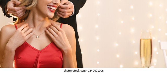 Unrecognizable Woman Getting Golden Necklace From Her Boyfriend For Valentine's Day During Romantic Dinner In Restaurant, Panorama With Free Space