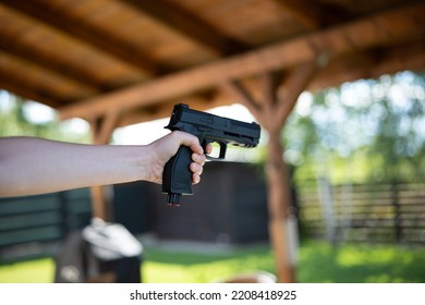 Unrecognizable Woman Holding And Aiming A Black Air Bb Gun.