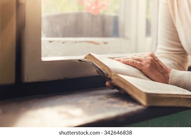 Unrecognizable Woman Holding A Bible In Her Hands