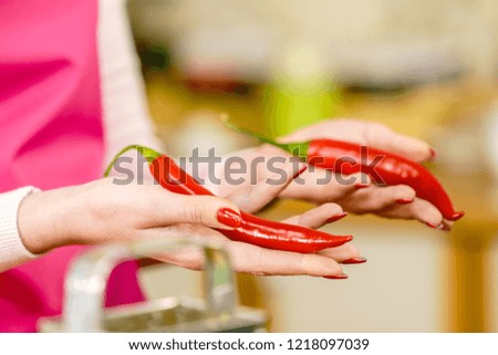 Unrecognizable woman holding red chilli hot pepper paprika. Spicy food, oriental seasonings concept.