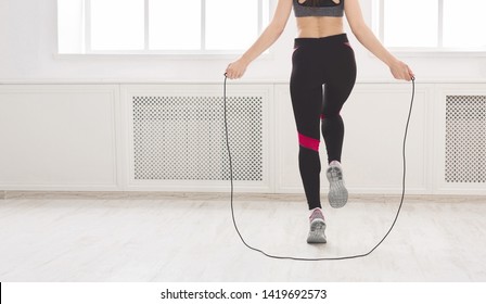 Unrecognizable Woman Jumping Over The Skipping Rope In Studio, Crop, Panorama, Free Space