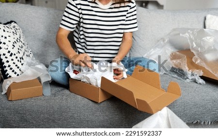 Similar – Image, Stock Photo Unrecognizable woman packing carton box with tape dispenser