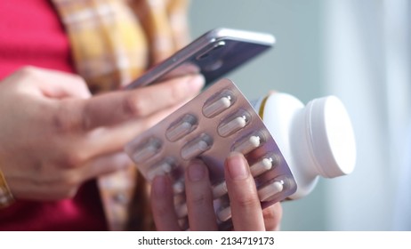 Unrecognizable Woman Reading Online Medication Instructions. Doctor And Online Consultation. Contraindications And Prescription Pills.