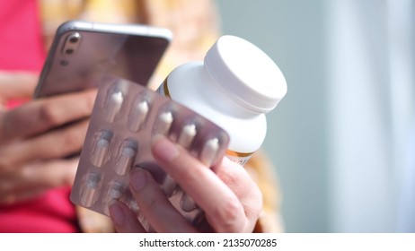 Unrecognizable Woman Reading Online Medication Instructions. Doctor And Online Consultation. Contraindications And Prescription Pills.