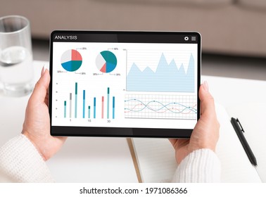 Unrecognizable Woman Using Financial App For Stocks And Markets Analysis On Digital Tablet At Home, Creative Image. Cropped Of Lady Analysing Financial Operations Online, Using Pad