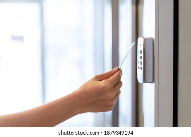 Unrecognizable Woman Using A Keycard Or Pass Card To Unlock And Access The Security Door At Apartment. Security System For Residential Area. Personal Identification System.