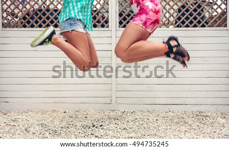 Similar – Happy women jumping in front of garden fence