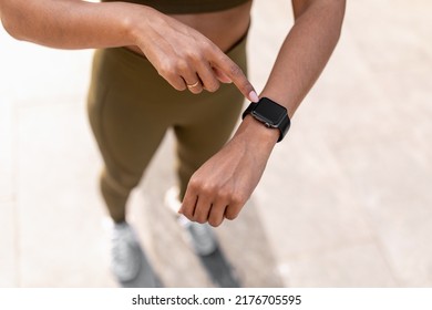 Unrecognizable young black woman using activity fitness tracker with mockup, checking heart rate and burned calories while jogging on city street, cropped view. Modern sports gadgets concept - Powered by Shutterstock
