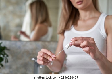 Unrecognizable Young Caucasian Woman Standing In The Bathroom And Holding A Tampon 