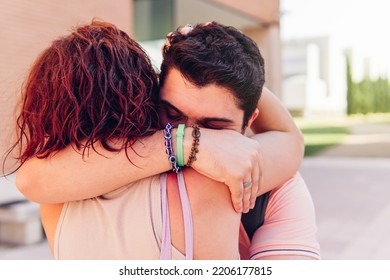 Unrecognizable Young Couple Hugging At A Meeting Outdoors. Anonymous People.