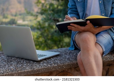 Unrecognizable Young Man Drawing On His Notebook About His Online Entrepeneur Project While Living Abroad