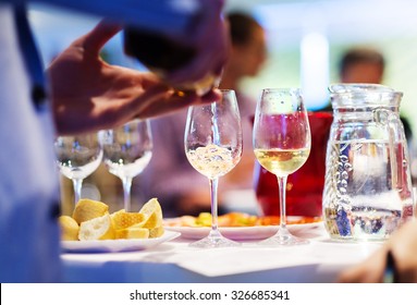 Unrecognizable Young Man Pouring Wine Into A Glass 