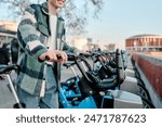 unrecognizable young man riding an electric bicycle. Sustainable and ecological transport concept.