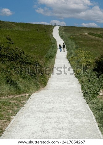 Unrecognized people trekking on a footpath in nature