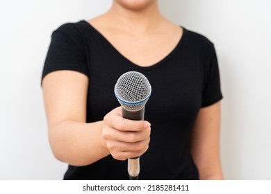 Unrecognized Person Holding Microphone On White Background.