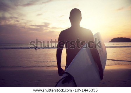 unrecognized Surfer in Sunset