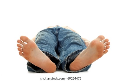 unrecognized young barefooted man lying on the floor