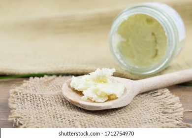 Unrefined shea butter, natural on a wooden spoon