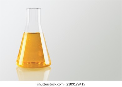 Unrefined Sunflower Oil In Chemical Flask On Desk Background.