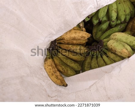 unripe bananas put in a sack