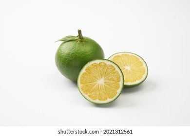 Unripe Japanese mandarin oranges on white background       