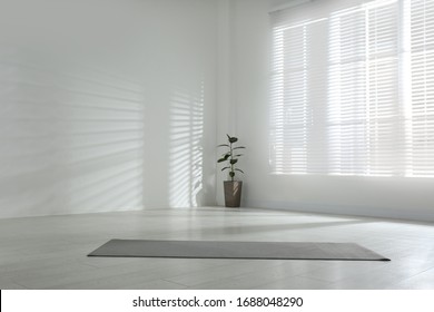 Unrolled grey yoga mat on floor in room. Space for text - Powered by Shutterstock