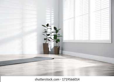 Unrolled Grey Yoga Mat On Floor In Room